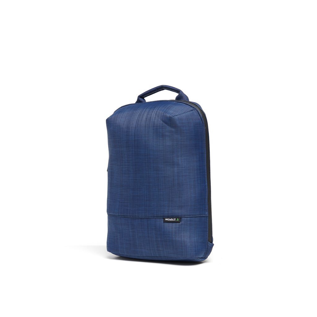 Mueslii small backpack,  made of  water resistant canvas nylon,  with a laptop compartment, color blue, side view.