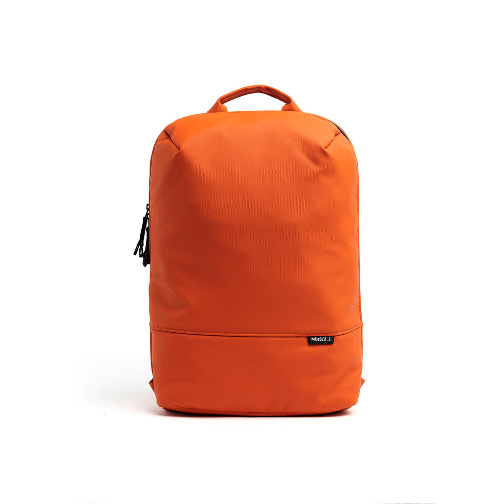 Mueslii travel backpack, made of PU coated waterproof nylon, with a laptop compartment, color orange, front view.