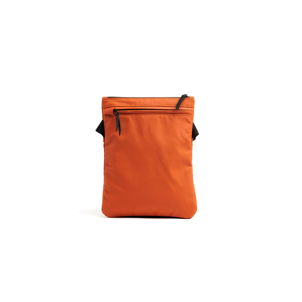 Mueslii crossbody, made of PU coated waterproof nylon, color burnt orange, back view.