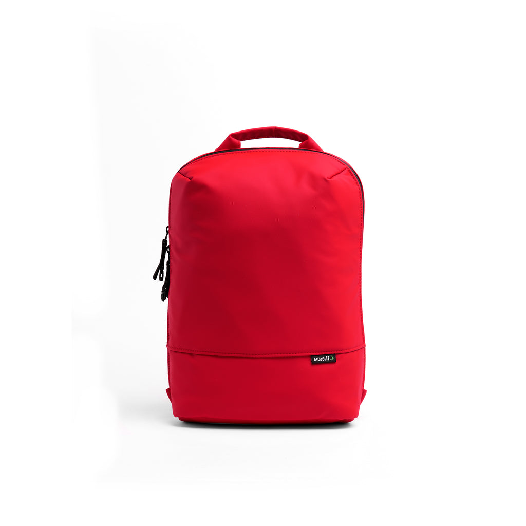 Mueslii small backpack, made of PU coated waterproof nylon, with a laptop compartment, color coral red, front view.