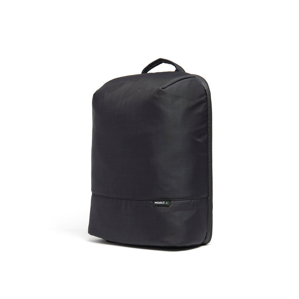 Mueslii travel backpack, made of water resistant canvas nylon, with a laptop compartment, cabin luggage, color night black, side view.