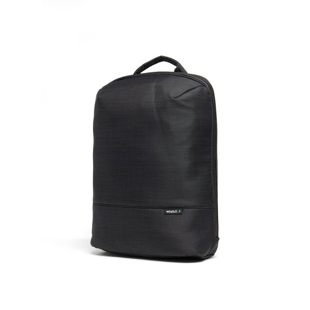 Mueslii daily backpack, made of  water resistant canvas nylon, with a laptop compartment, color black, side view.