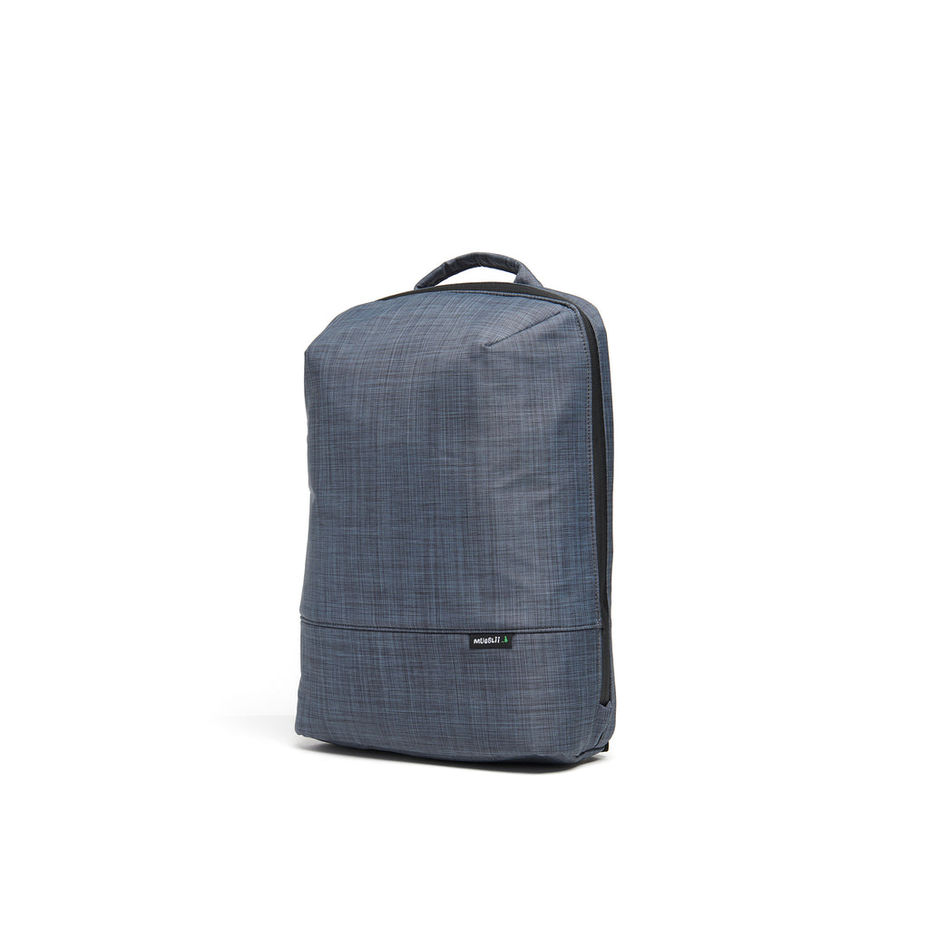Mueslii small backpack,  made of  water resistant canvas nylon,  with a laptop compartment, color slate grey, side view.