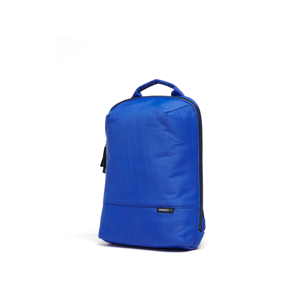 Mueslii small backpack,  made of  water resistant canvas nylon,  with a laptop compartment, color summer blue, side view.