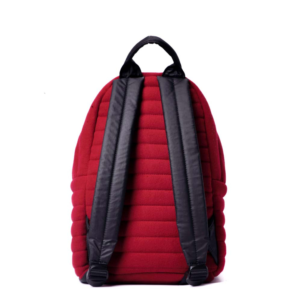 Mueslii original puffer small backpack made of woven cloth and Ykk zips, color red, back view.