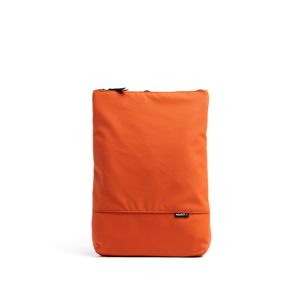 Mueslii light backpack,  made of PU coated waterproof nylon, with a laptop compartment, color burnt orange, front view.