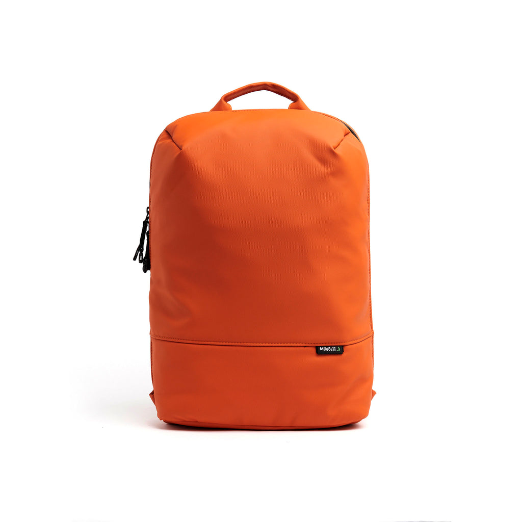 Mueslii daily backpack, made of PU coated waterproof nylon, with a laptop compartment, color burnt orange, front view.