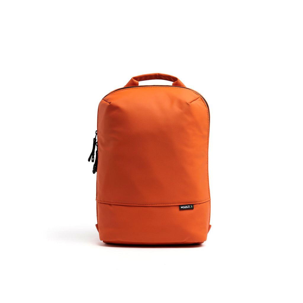 Mueslii small backpack, made of PU coated waterproof nylon, with a laptop compartment, color burnt orange, front view.