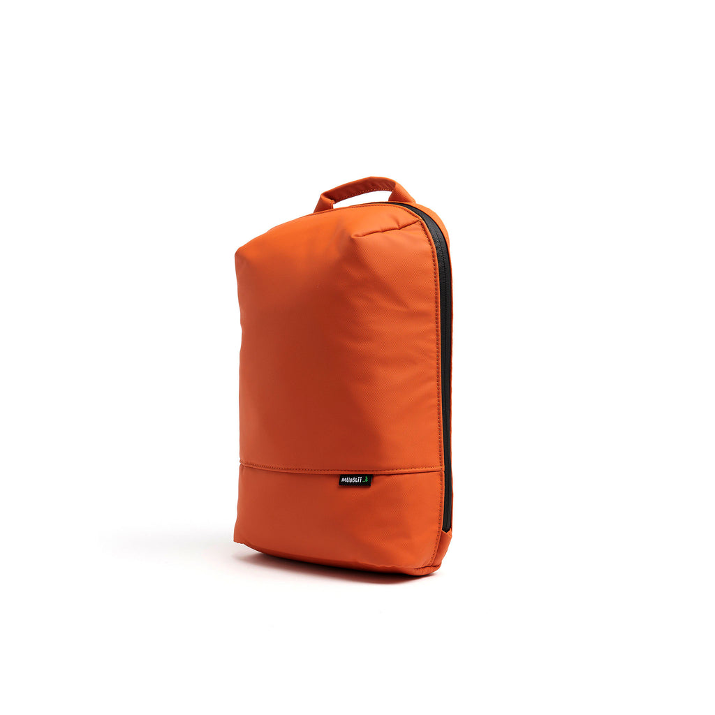 Mueslii small backpack, made of PU coated waterproof nylon, with a laptop compartment, color orange, side view.