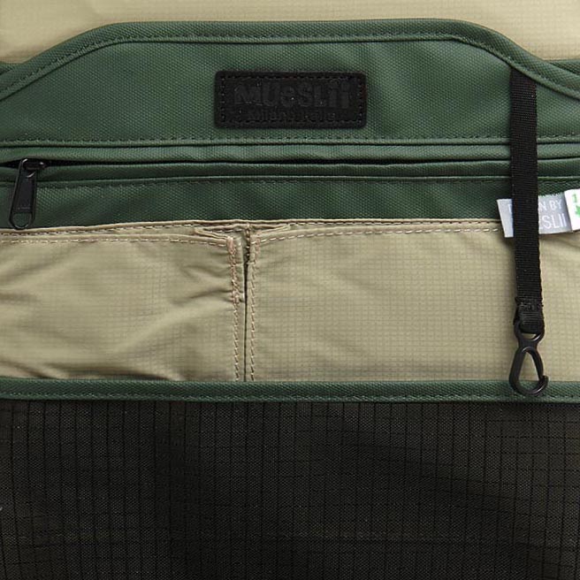 Mueslii small backpack, made of PU coated waterproof nylon, with a laptop compartment, color green, inside view.